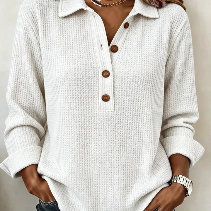 Close up of white waffle knit top with button placket and collar