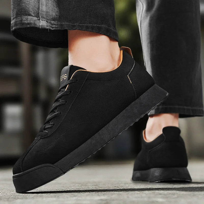 Rear view of black sneaker worn on foot walking outdoors