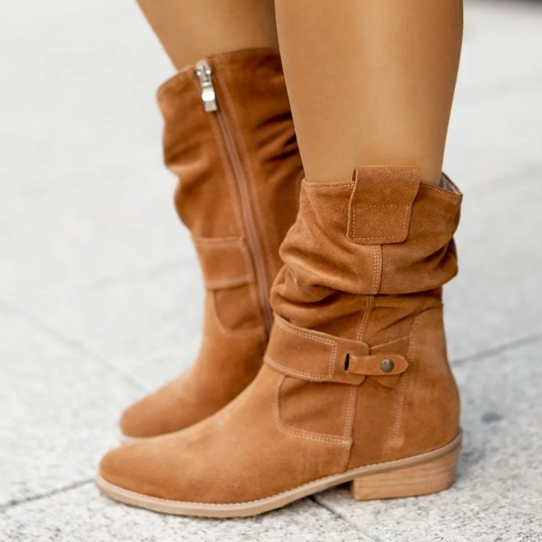 Brown suede slouch ankle boots with buckle strap, side view