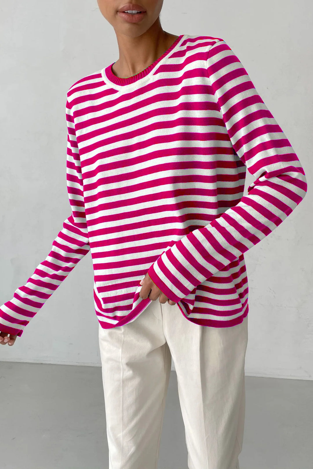 Woman wearing pink and white striped knit sweater