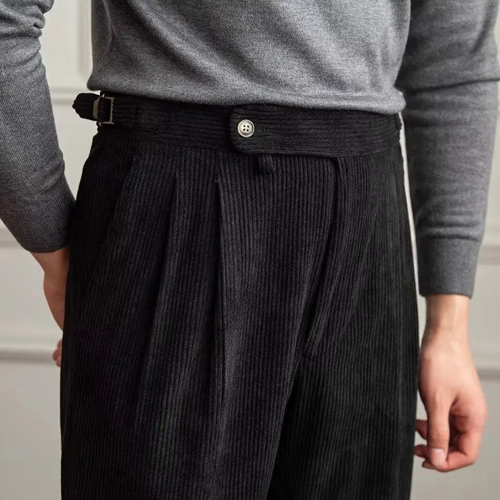 Close up of black corduroy trousers waistband and pleats