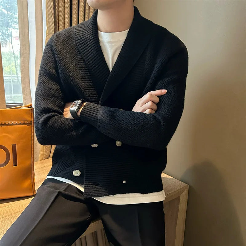 Man wearing black double breasted shawl collar cardigan with arms crossed