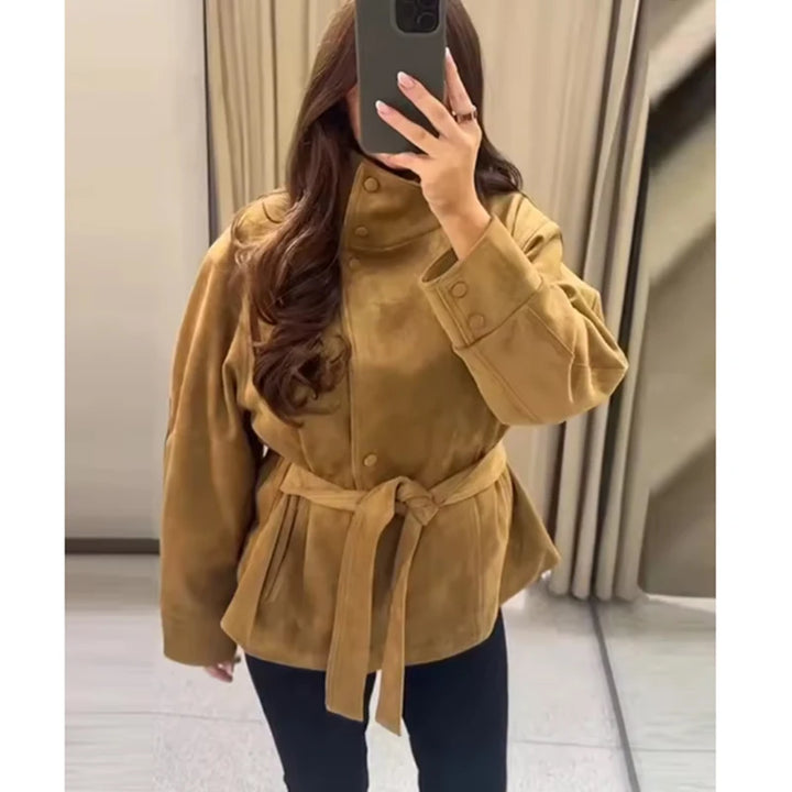 Woman wearing camel belted jacket with tied waist belt