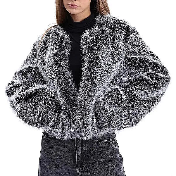 Woman wearing black and white faux fur cropped coat open front