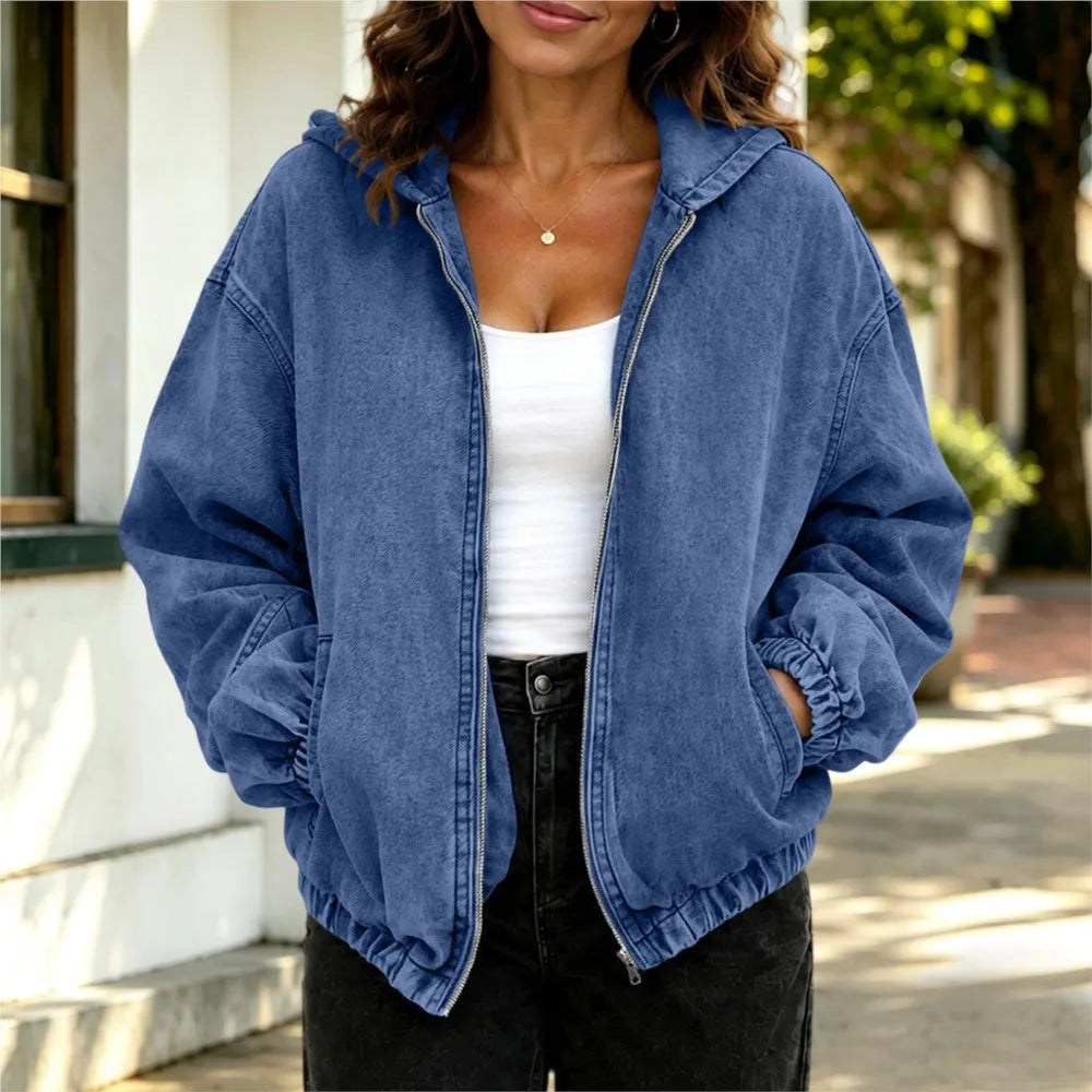 Woman wearing blue oversized hooded denim jacket, front view