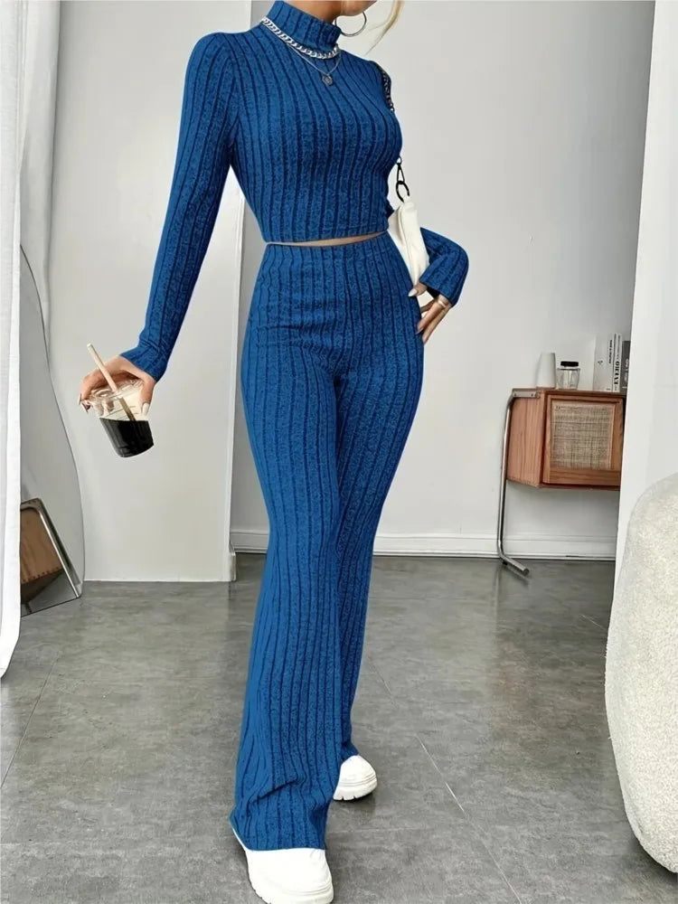 Woman wearing blue ribbed knit crop top and flare pants set, front view
