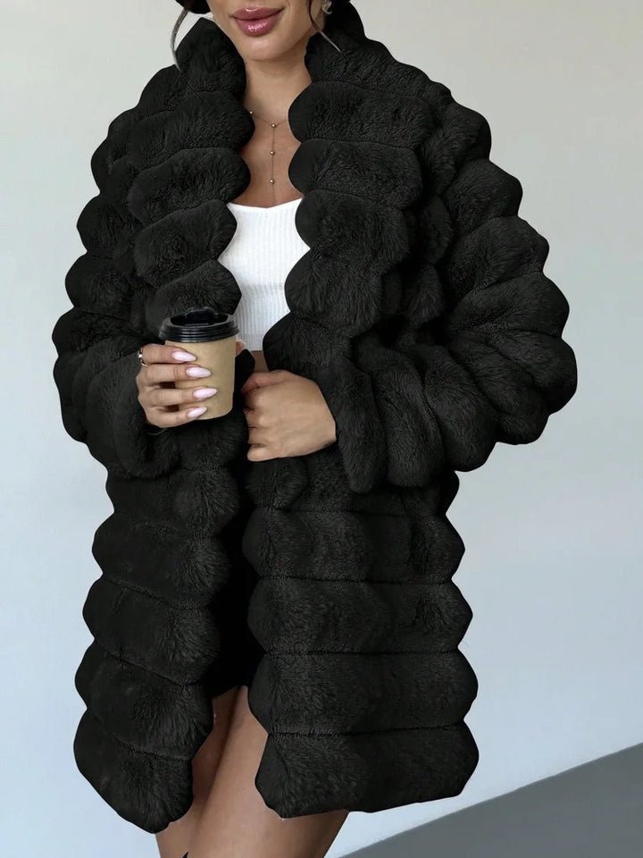 Close up of black faux fur coat with turn down collar