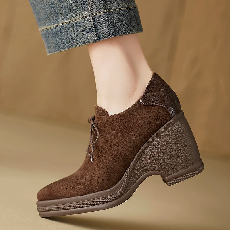 Brown suede lace-up wedge pump worn on foot, side view