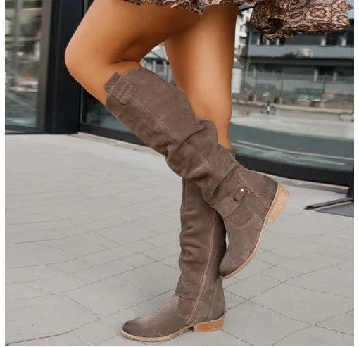 Dark brown suede knee-high boots with buckle detail, side view