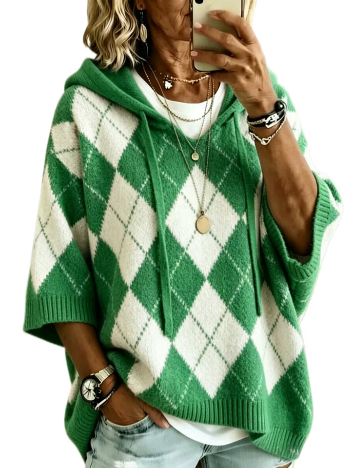 Woman wearing light green argyle hooded knit sweater, front view