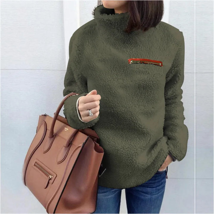 Woman wearing army green sherpa turtleneck pullover with zip chest pocket