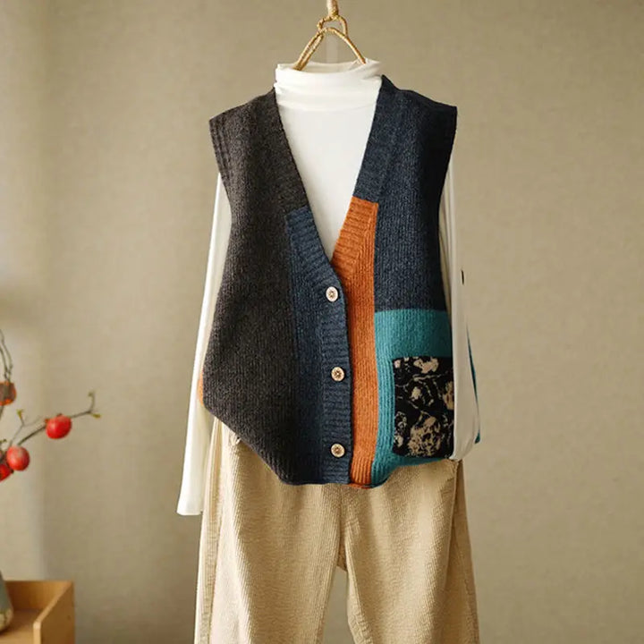 Colorblock knit sweater vest in charcoal and orange with floral patch pocket, front view