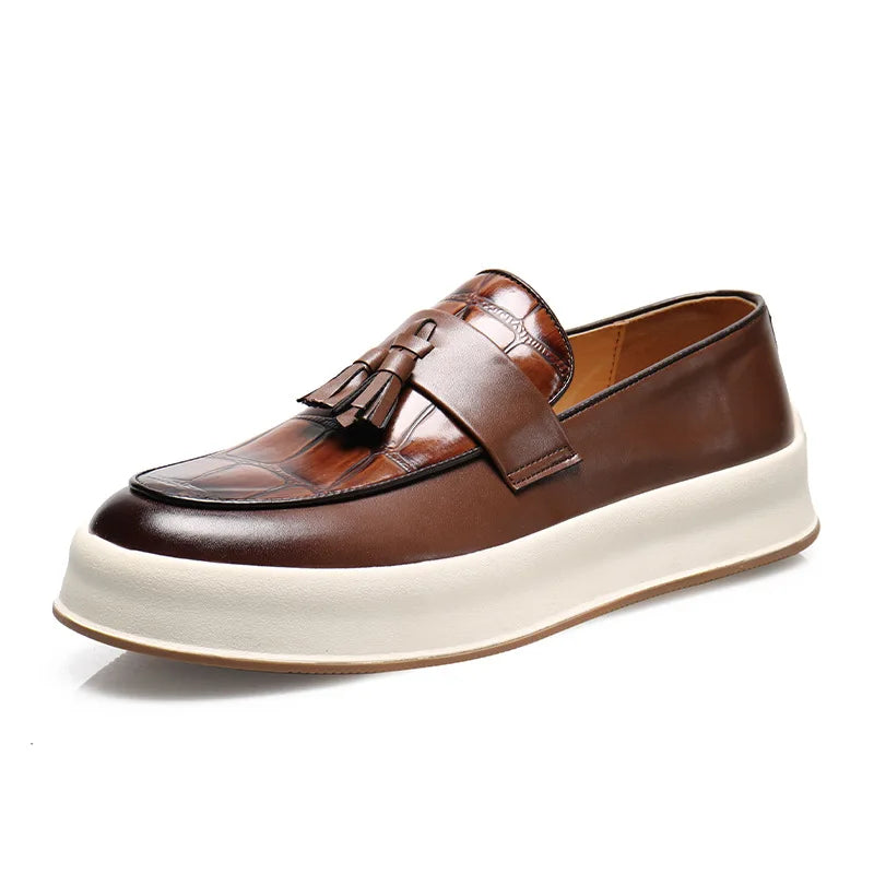 Brown tasseled loafer with croc-embossed toe on white background