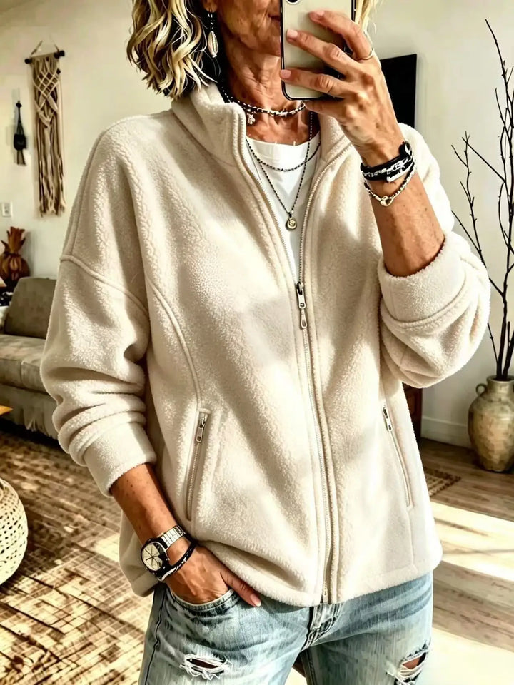 Woman wearing ivory fleece full zip jacket with stand collar