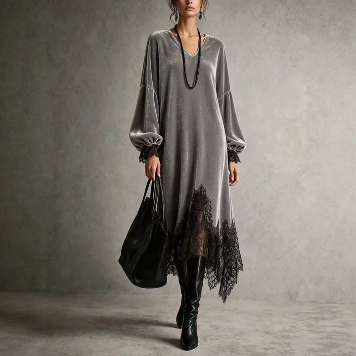 Woman wearing gray velvet midi dress with lace trim and V neckline