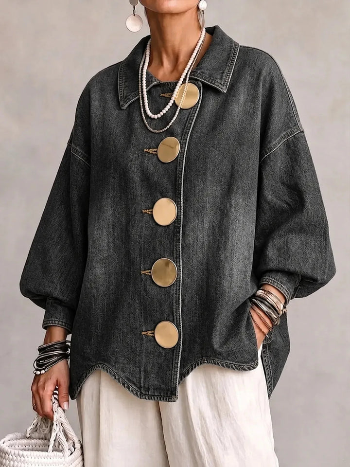 Woman wearing gray denim jacket with large gold buttons, front view