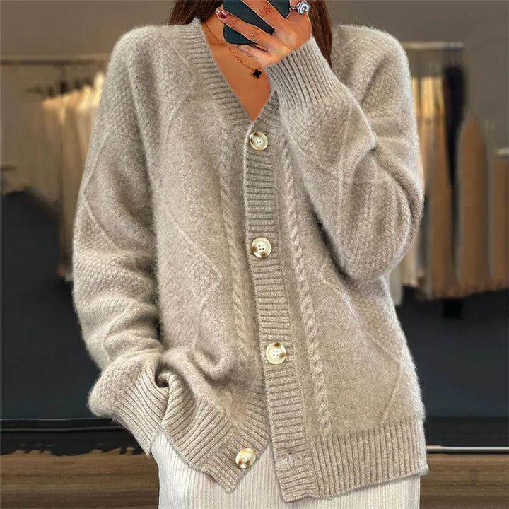 Woman wearing camel cable knit button front cardigan