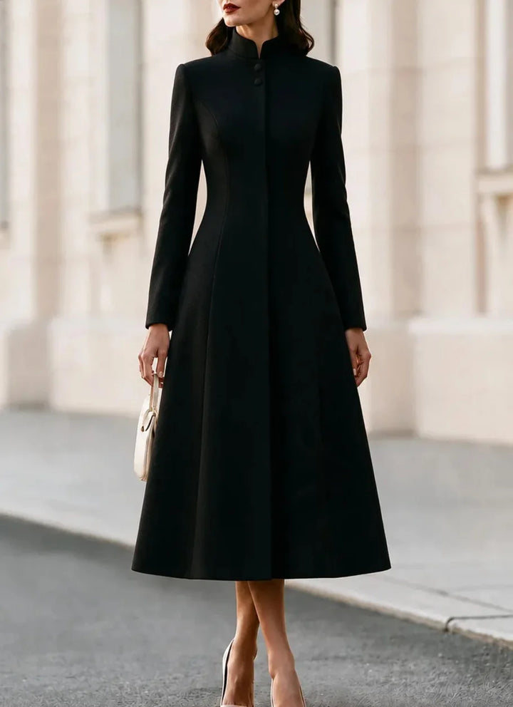 Woman wearing black stand collar coat dress, close up front view