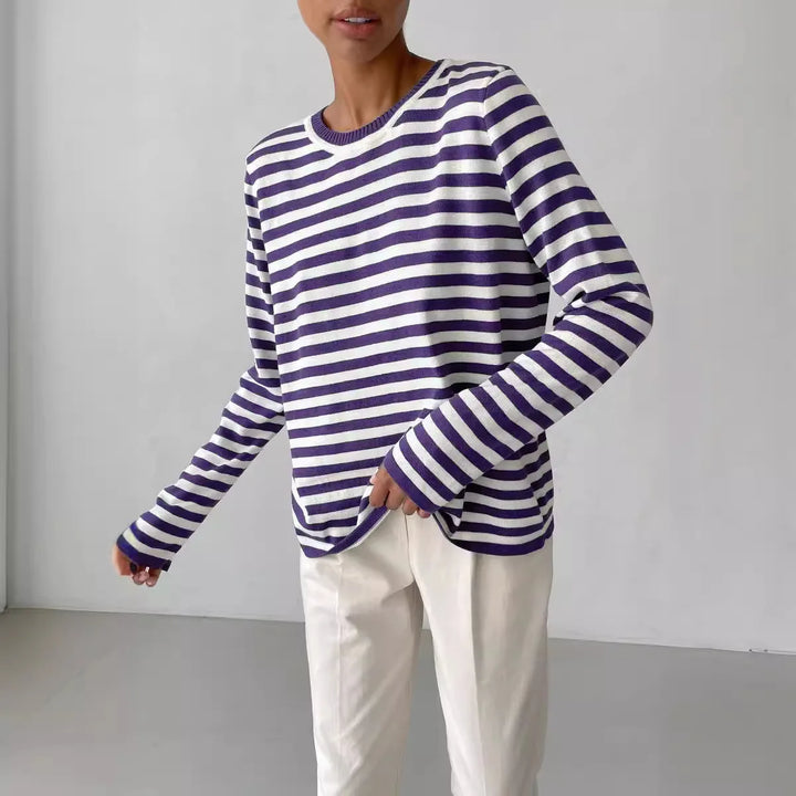 Woman wearing purple and white striped knit sweater