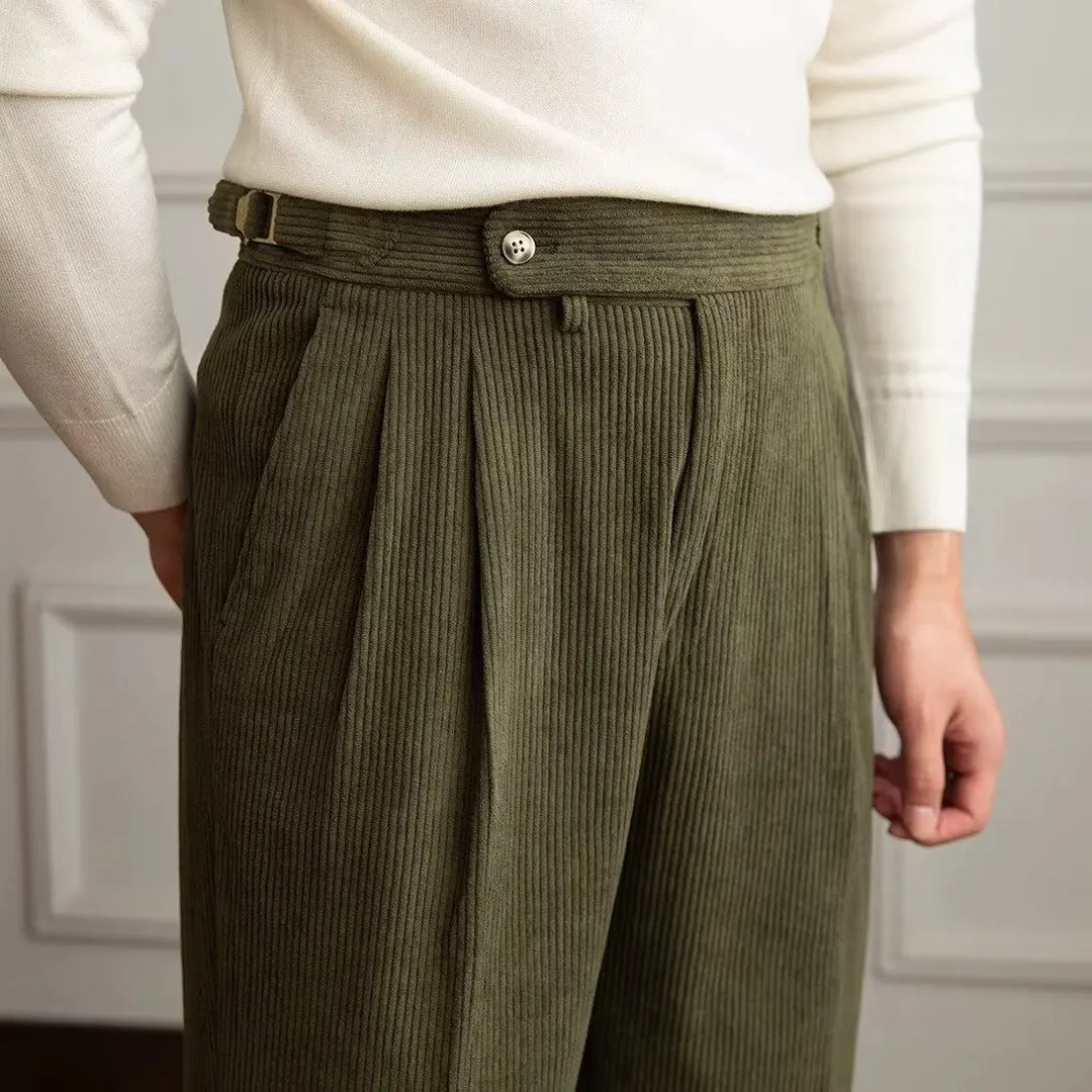 Close up of green corduroy trousers waistband and pleats