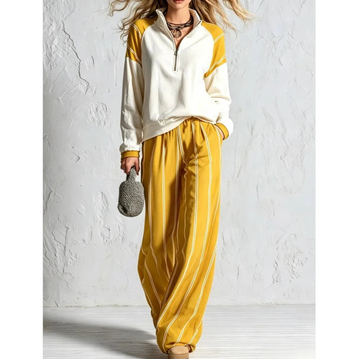 Woman wearing yellow color block quarter zip pullover and yellow striped wide leg pants, front view