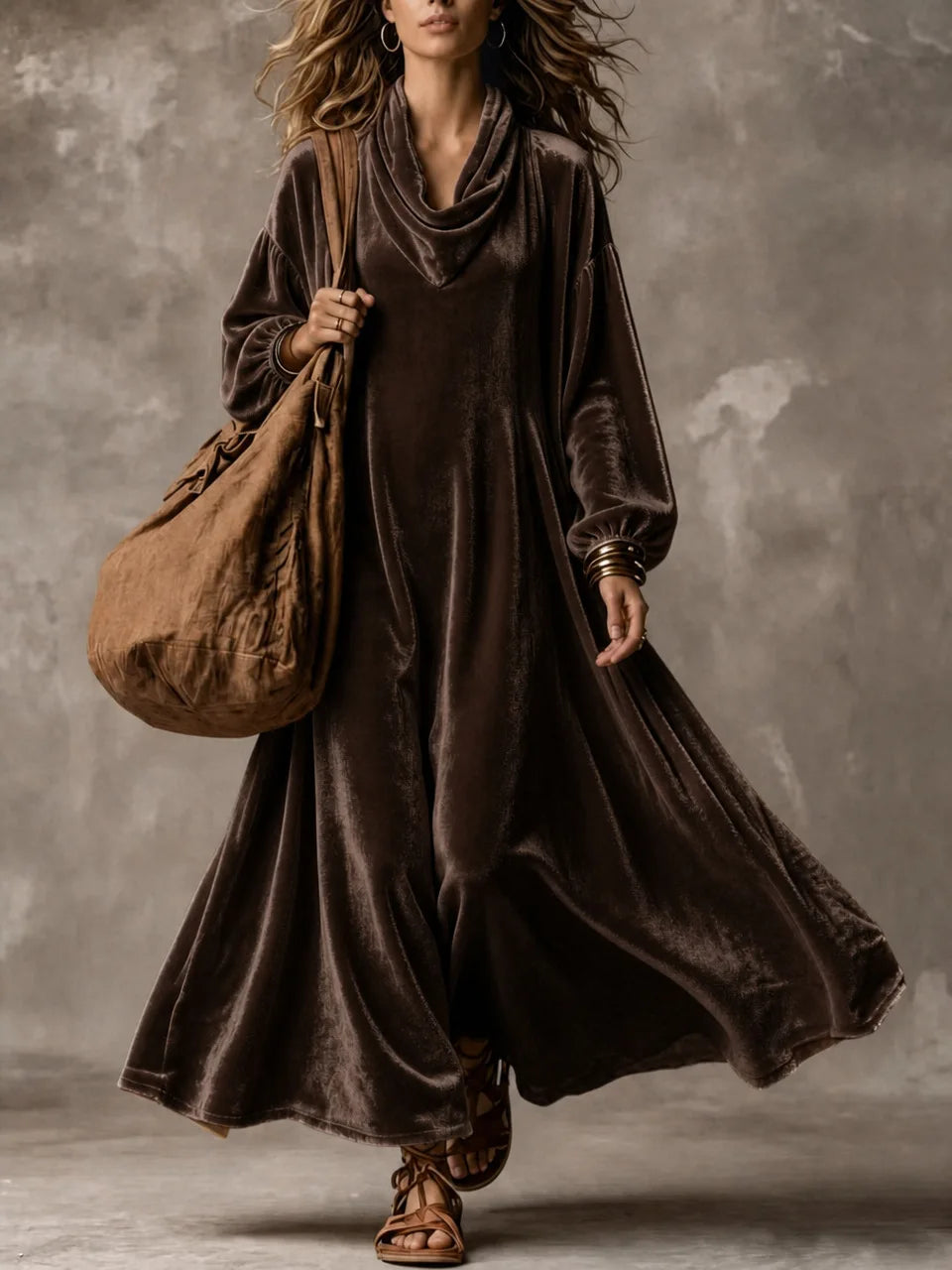 Woman wearing dark brown velvet cowl neck maxi dress