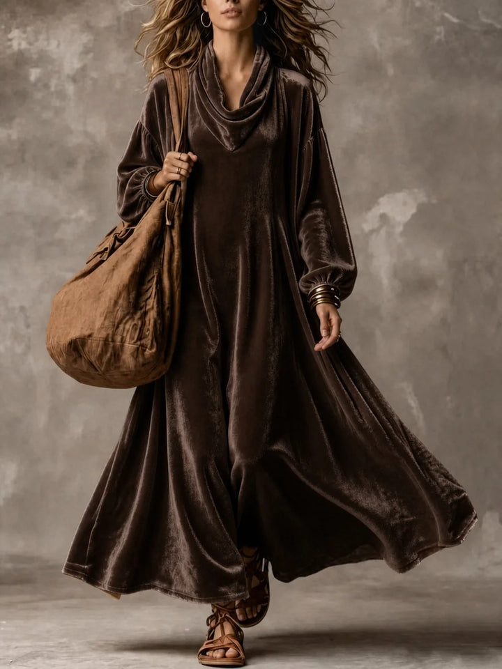 Woman wearing dark brown velvet cowl neck maxi dress