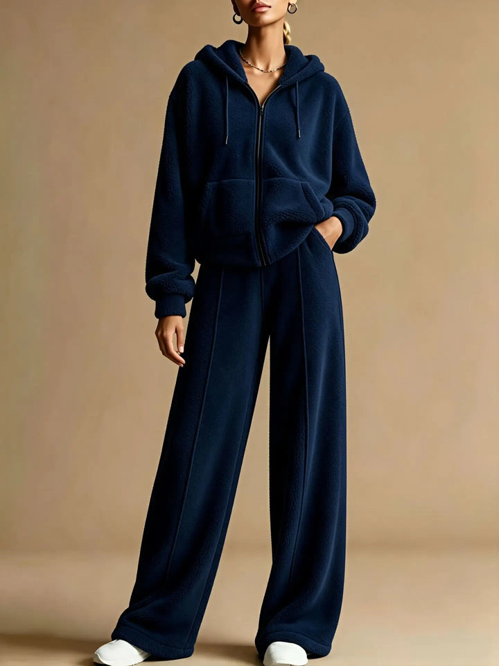 Woman wearing navy blue sherpa hoodie and pants set, close up