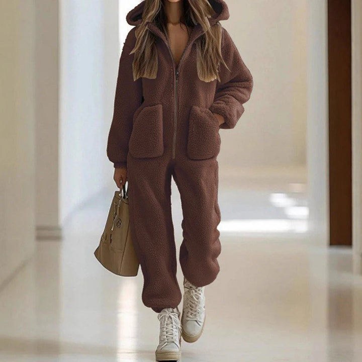 Woman wearing brown sherpa hooded jumpsuit with patch pockets