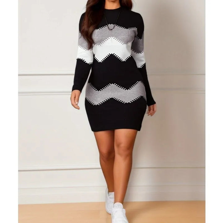 Black and white chevron striped sweater dress, front view with sneakers