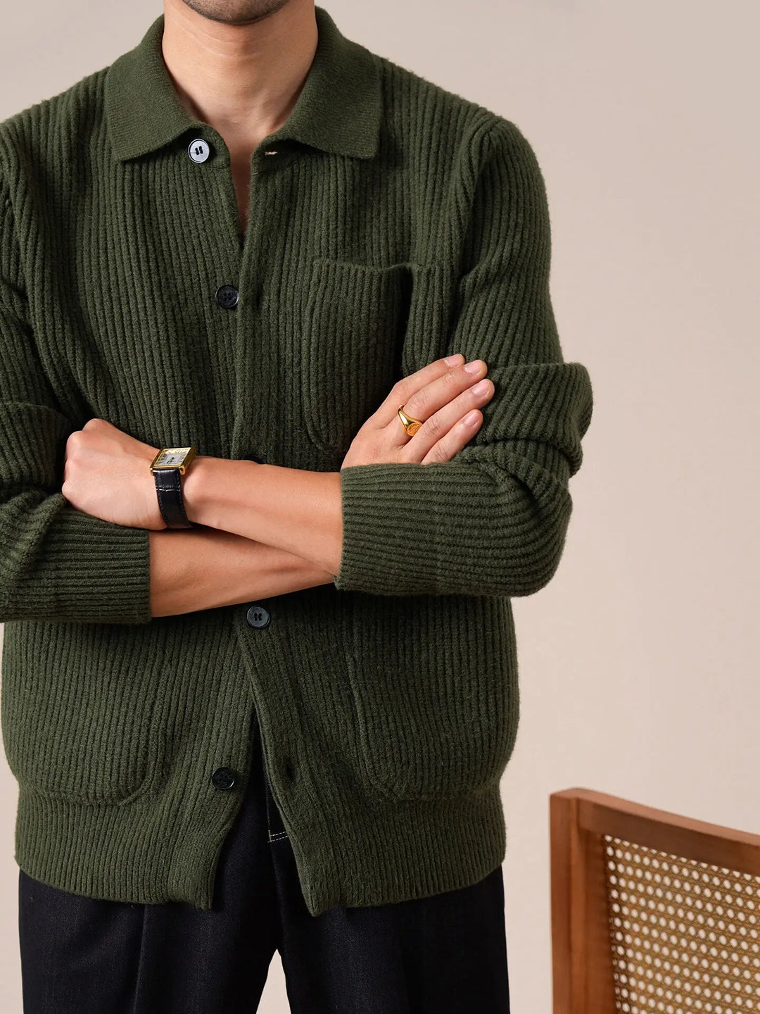 Army green ribbed knit cardigan with arms crossed showing sleeve detail