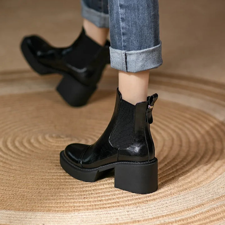 Model walking in black Chelsea platform boots