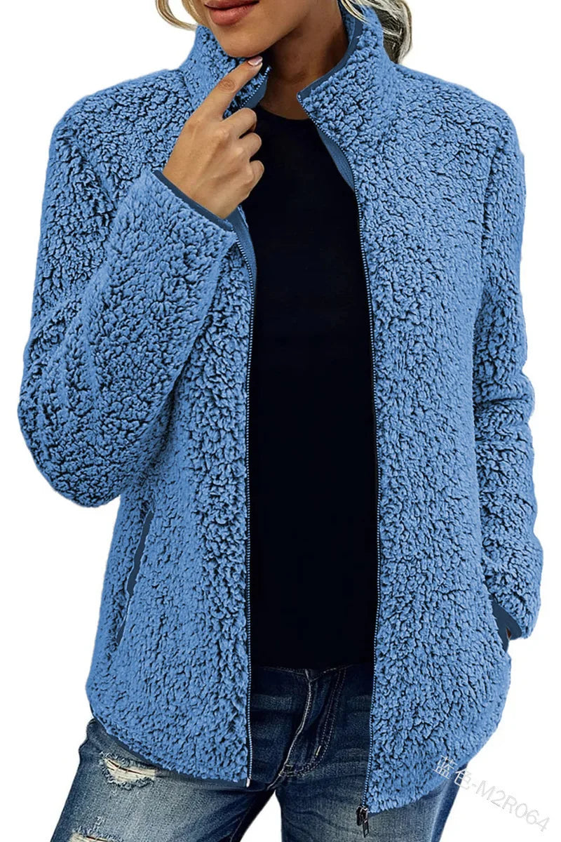 Woman wearing blue sherpa fleece zip jacket with stand collar