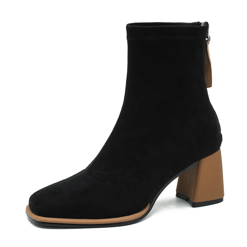 Black suede-look ankle boot with tan block heel, side profile on white background
