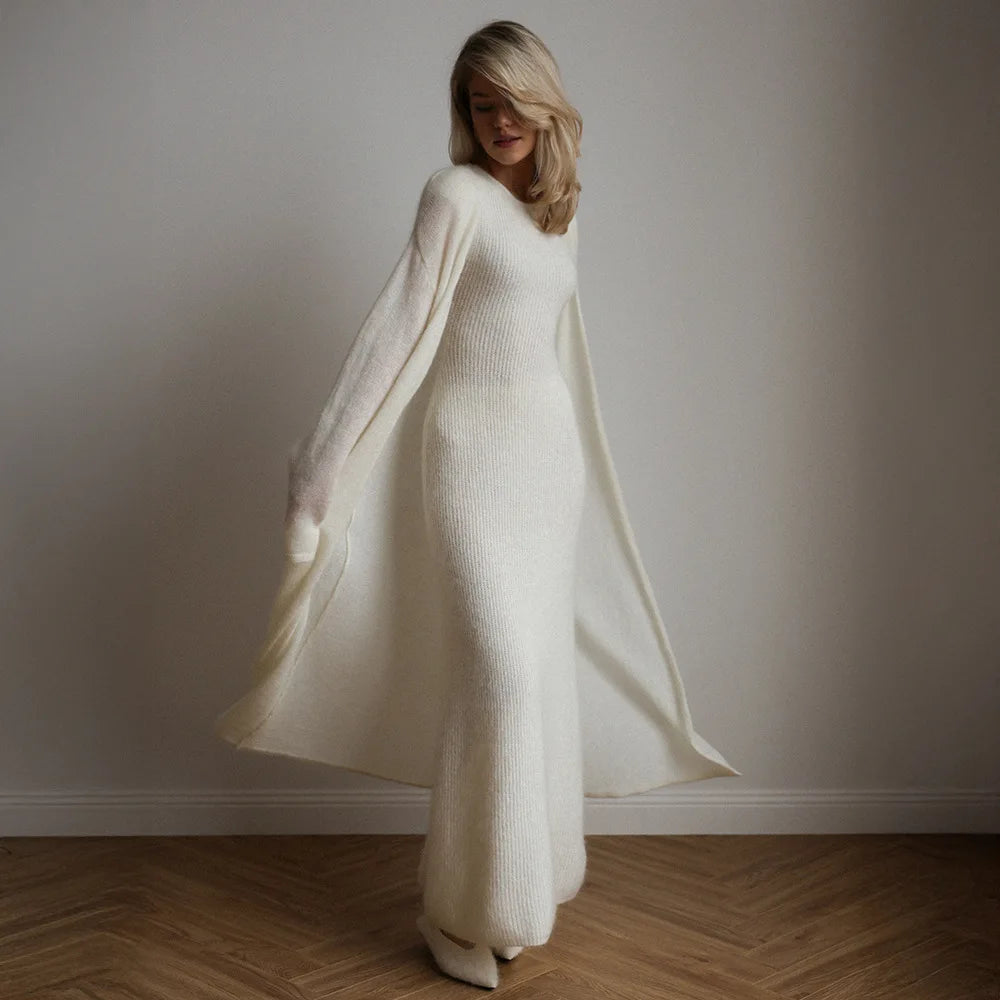 Woman in motion wearing white ribbed knit dress with flowing duster
