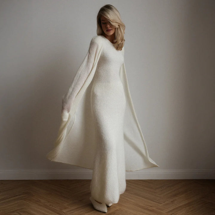 Woman in motion wearing white ribbed knit dress with flowing duster