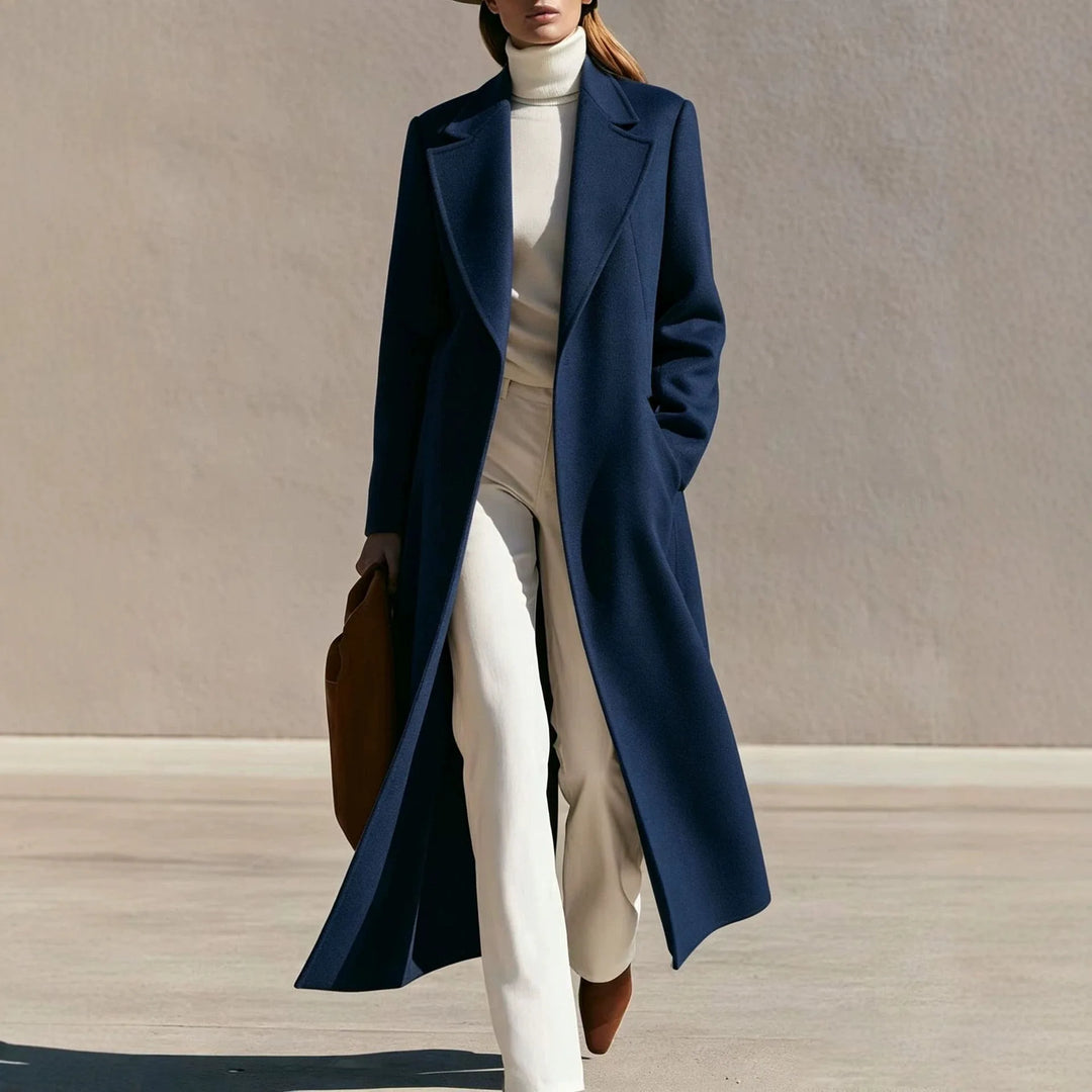 Woman wearing long navy wool-blend coat with notched lapel walking outdoors