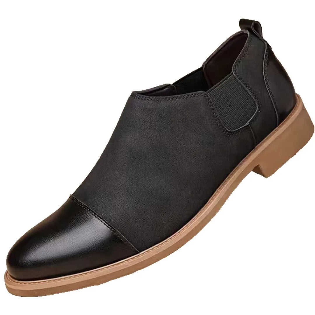 Black cap toe Chelsea boot, close angled view on white background