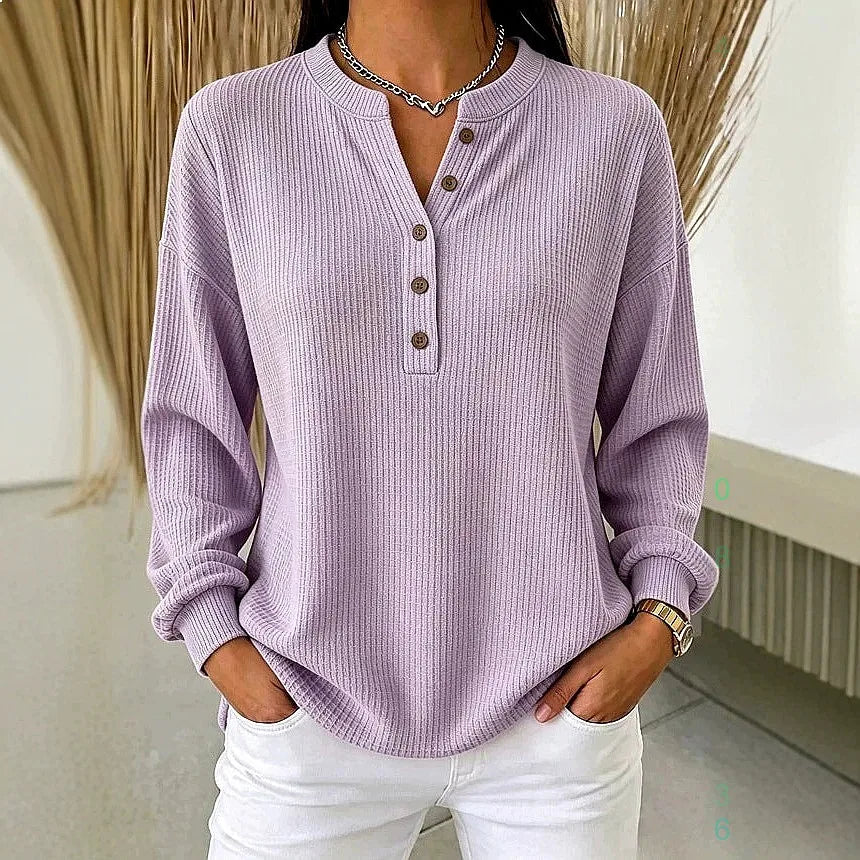 Woman wearing lavender purple ribbed knit henley top with button placket