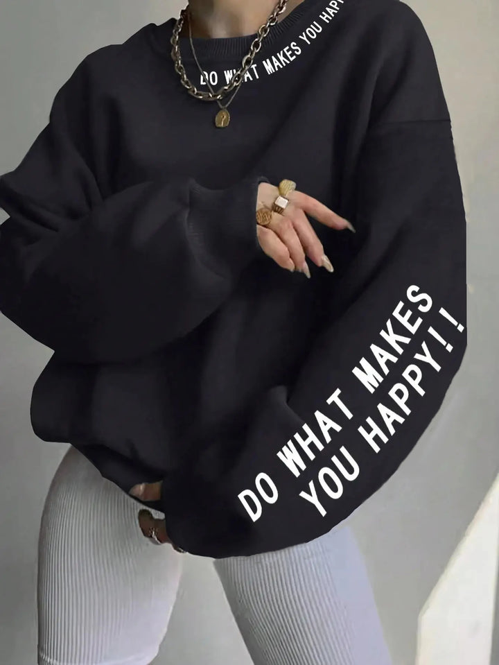 Woman wearing oversized black graphic sweatshirt with sleeve print