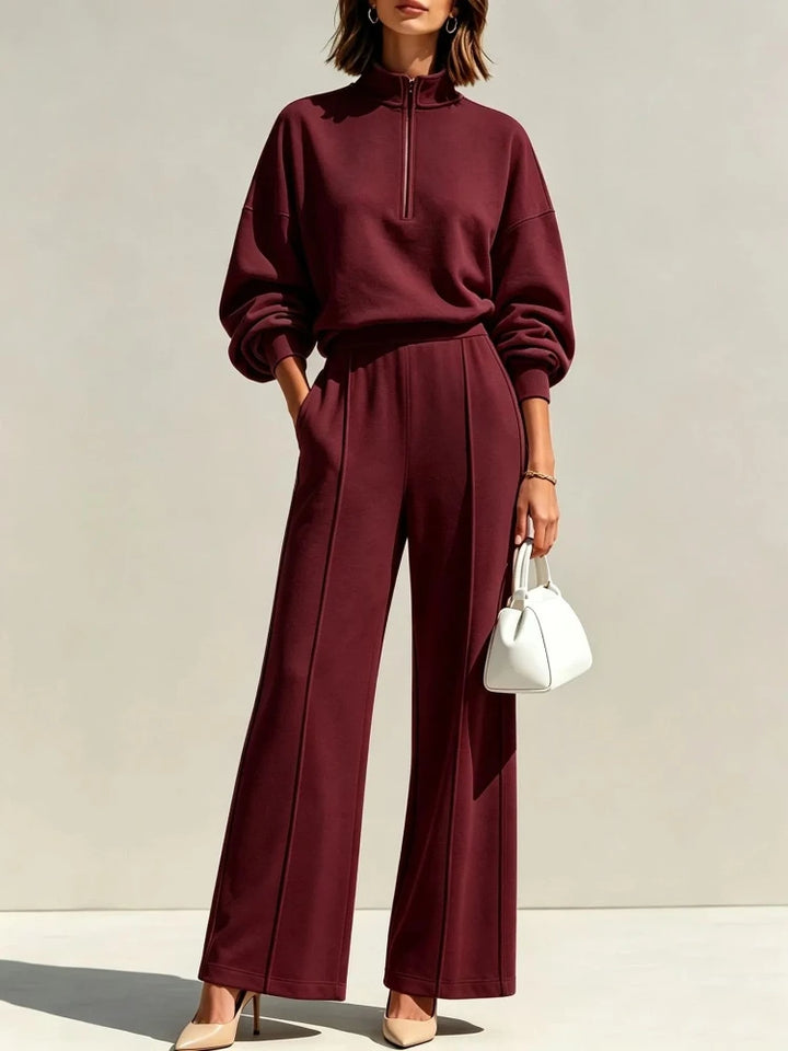 Woman wearing burgundy quarter zip pullover and wide leg pant set
