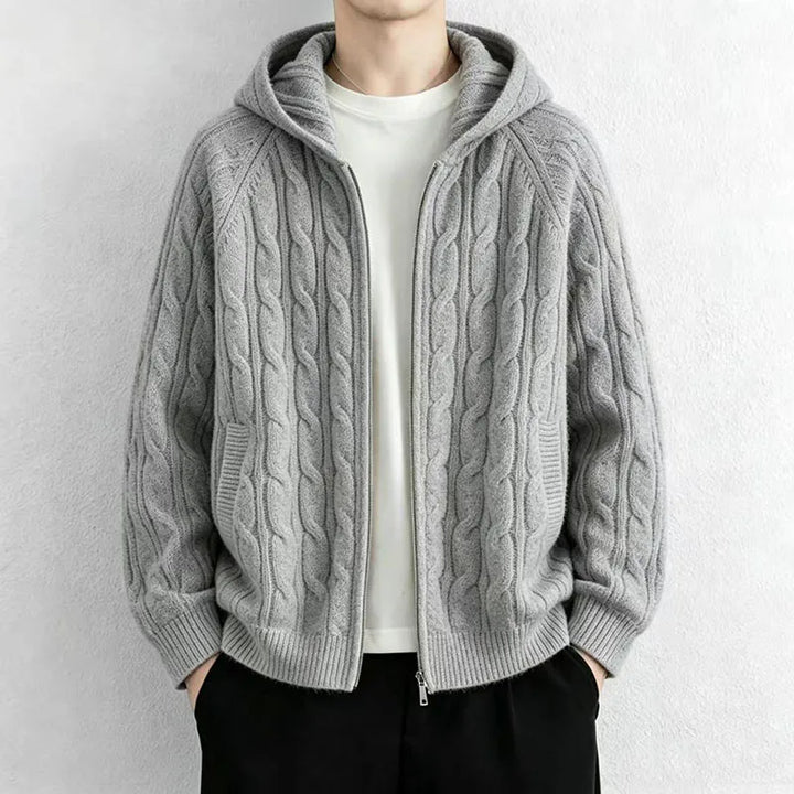 Man wearing light grey cable knit hooded cardigan with front zip