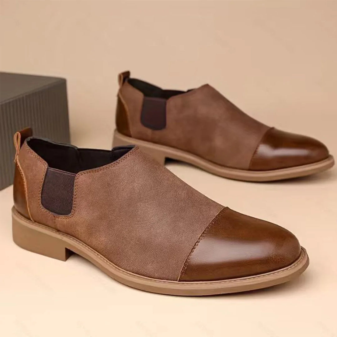 Brown cap toe Chelsea boots with elastic side gussets, side view