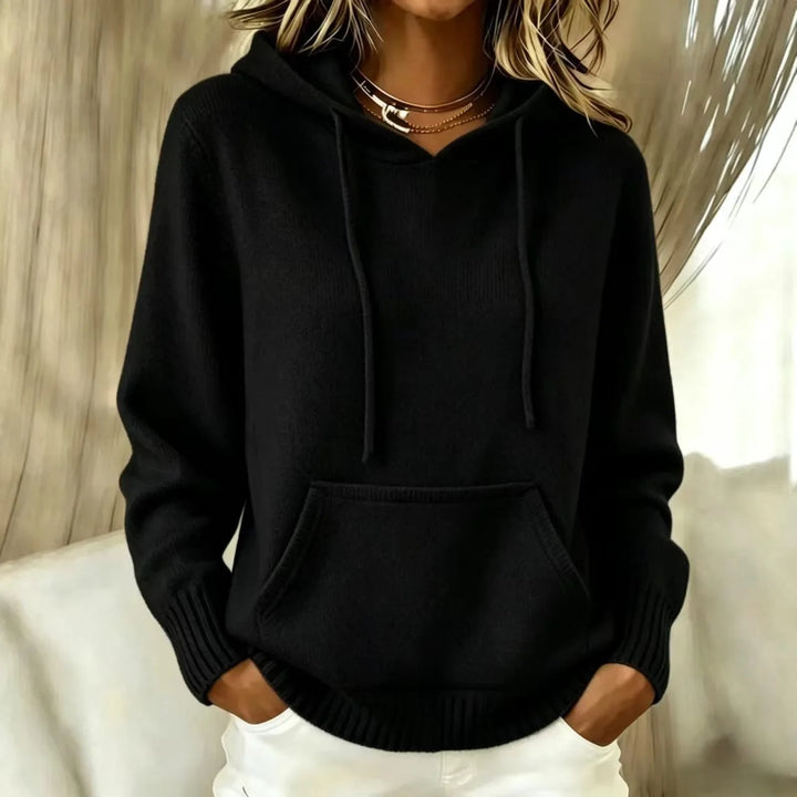 Woman wearing black hooded knit sweater with kangaroo pocket