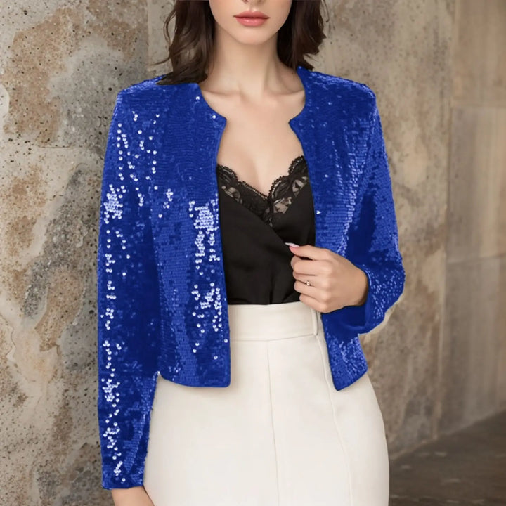 Blue sequin cropped jacket worn open over black lace top