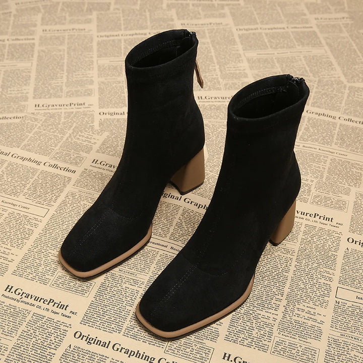 Pair of black suede-look ankle boots with contrast block heel, side angle