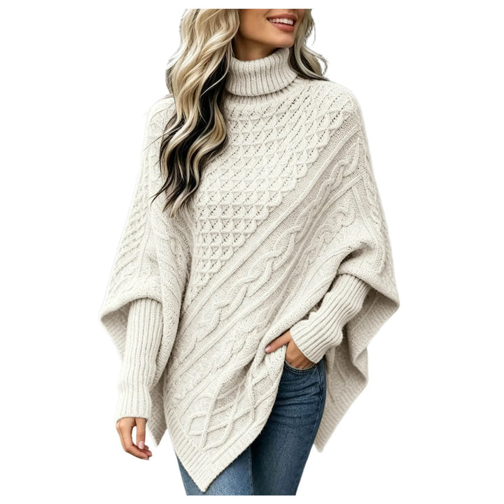 Woman wearing beige cable knit asymmetric poncho sweater with turtleneck