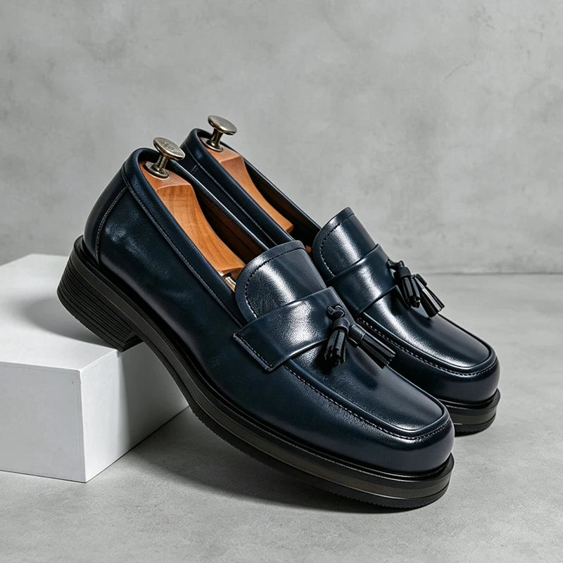 Pair of navy blue tassel loafers on shoe trees