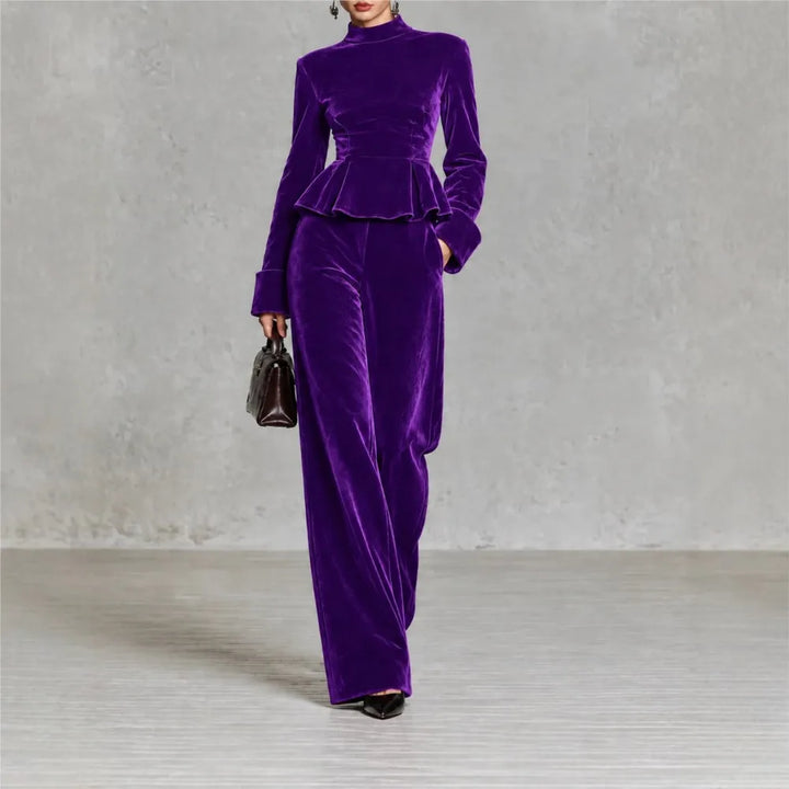 Woman wearing purple velvet peplum top and wide leg pants set, front view