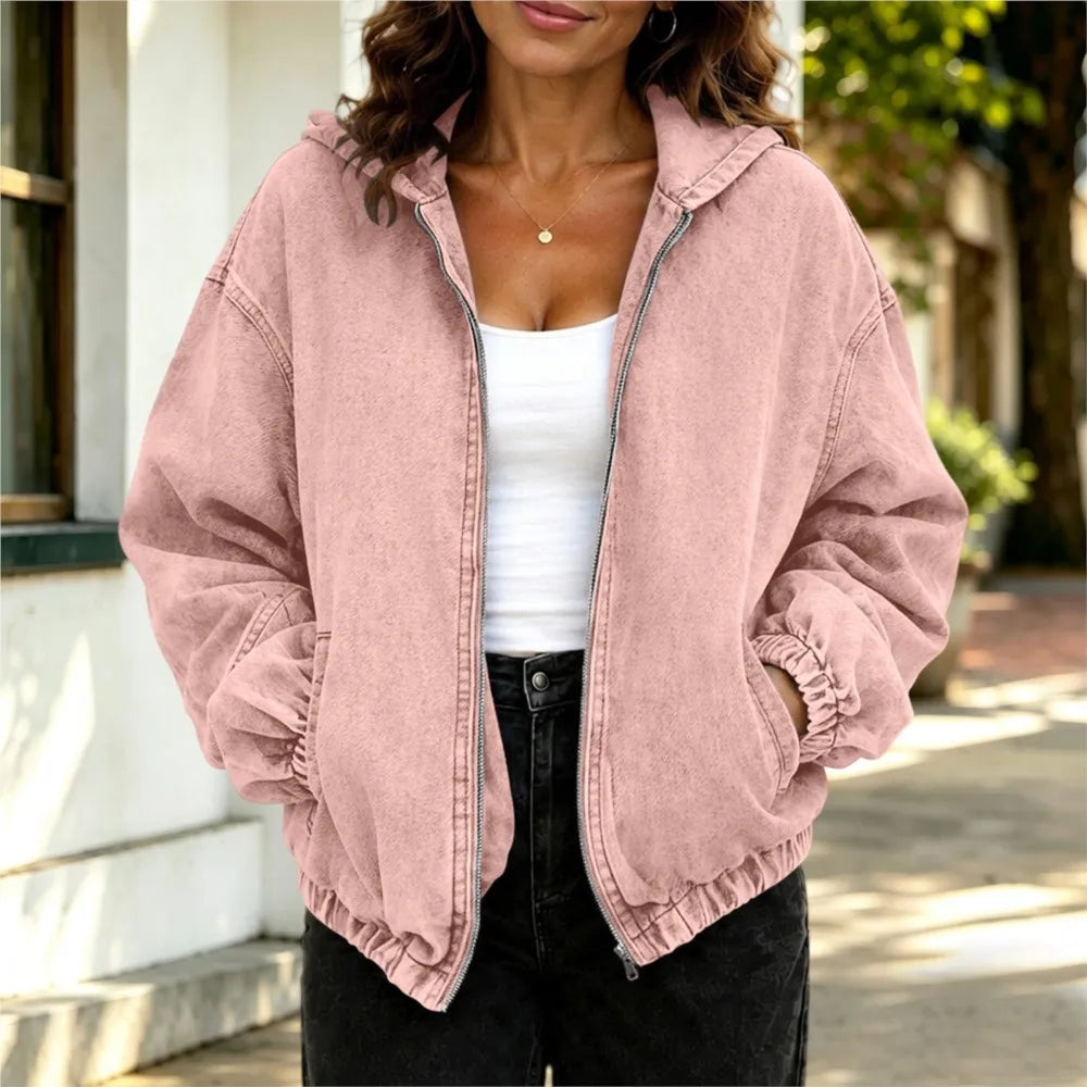 Woman wearing pink oversized hooded denim jacket, front view